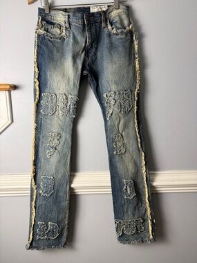 Distressed Light Blue Men's Denim Jeans with Frayed Patchwork